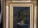une image représentant une photo d'un tableau posé sur une chaise dans une pièce