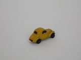 yellow toy car sitting on a white surface in the snow