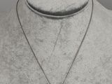 a close up of a necklace on a mannequin mannequin