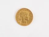 l'image d'une pièce d'or sur laquelle figure le visage d'une femme
