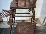 a wooden chair that is sitting on top of a table