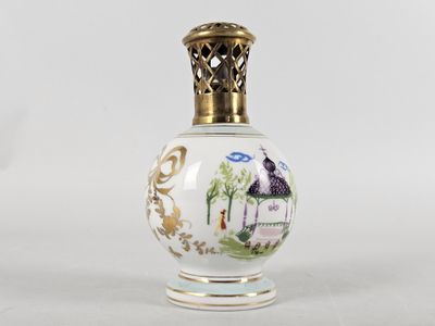 a small glass bottle with a gold lid on a white surface
