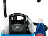 a blue and white steam cleaner and a bottle of cleaner