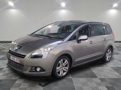 a picture of a silver minivan parked on a checkered floor