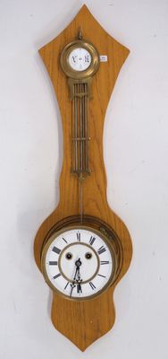 a wooden clock hanging on the wall with roman numerals