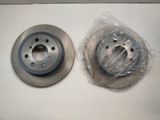 a close up of two brake discs on a white surface