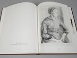 an open book with a drawing of a woman sitting on a chair