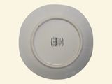 a white plate with a black and white design on it
