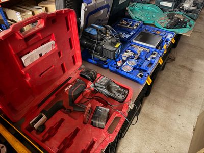 a red tool box with tools in it on the floor