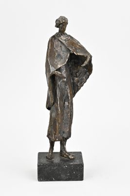 an image of a bronze statue of a man standing on a marble base