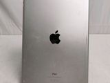a close up of a silver ipad sitting on top of a table