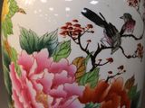 a vase with a bird and flowers painted on it