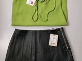 green top and black leather skirt with a tag on it