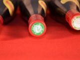 several bottles of wine are lined up on a red surface