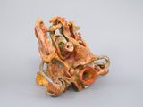 sculpture of an octopus made of clay on a gray surface