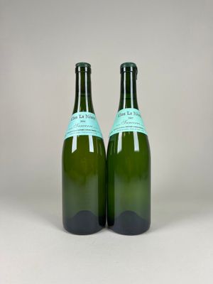 two bottles of wine sitting next to each other on a white surface