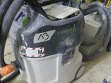 a vacuum that is sitting on the floor in the garage