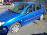 a small blue car parked on the side of the road