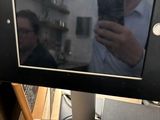 a man taking a picture of himself in the mirror