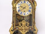 a clock hanging on the wall with a bird on it