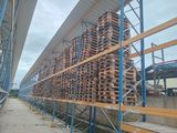 a large amount of pallets stacked up on the side of a building