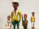 three figurines of a man with a hat and two men holding guns