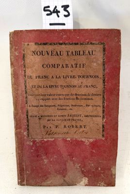 an old book sitting on top of a table next to a tag