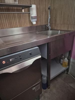 a kitchen with a sink and a dishwasher in it