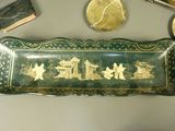 a green tray with a picture on it next to other items