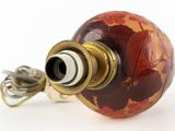 an image of a red and gold lamp with a cord