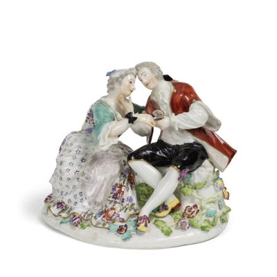 une figurine représentant un homme et une femme assis sur un banc