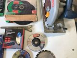 a table with a lot of tools on it that include a circular saw, a circular blade, a circular saw blade, a circular saw, and a