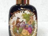 a black vase with a picture of a couple of people on it