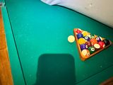 a pool table with a pool ball and a racket on it