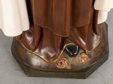 a statue of a person wearing a robe and shoes