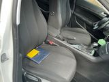 the interior of a car with the door open and the seat up