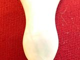 a white light bulb that is on a red surface