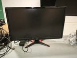 a computer monitor sitting on top of a desk