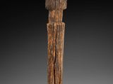 a close up of a wooden object on a black background