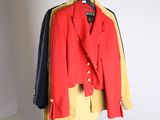 a red jacket hanging on a hanger in a white room