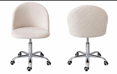 two white chairs sitting next to each other on casteors