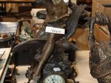 a statue of a woman sitting on top of a clock