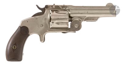 an old revolver with a wooden handle on a white background