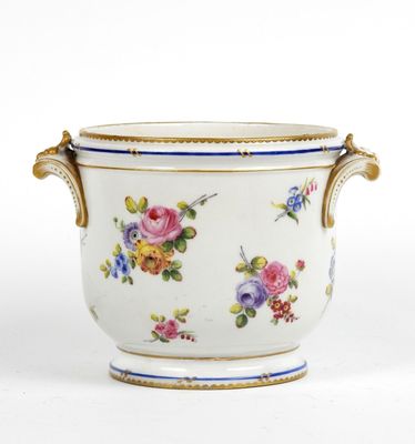 a white vase with flowers on it on a white surface