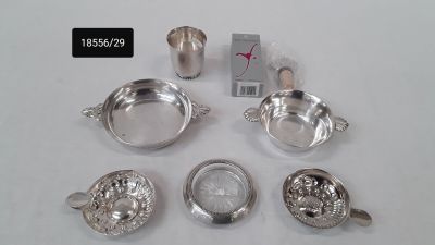 silver plated teapots, cups and saucers are on a white surface