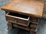 a small wooden table with a drawer underneath it