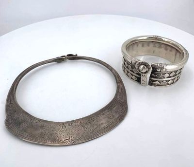 two silver rings and a silver ring on a white table
