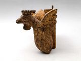 an image of a statue of a bird with wings on it ' s head