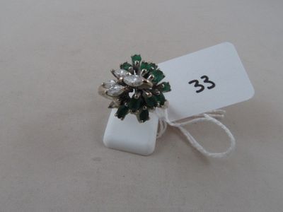 an image of a ring with green and white stones and a price tag