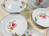 several plates and bowls are arranged on a white surface